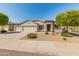 Single-story home showcasing a well-kept front yard, complemented by desert landscaping and a spacious three car garage at 13806 W Remuda Dr, Peoria, AZ 85383