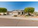 Charming single-story home featuring a well-manicured front yard with desert landscaping and a three car garage at 13806 W Remuda Dr, Peoria, AZ 85383