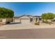 Beautifully maintained single-story home featuring a xeriscaped yard with mature trees and a three car garage at 13806 W Remuda Dr, Peoria, AZ 85383