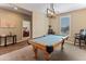 Game room featuring a billiards table beneath a modern chandelier, with neutral walls and a carpeted floor at 13806 W Remuda Dr, Peoria, AZ 85383