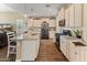 Spacious kitchen features white cabinets, granite countertops, stainless steel appliances, and modern lighting at 13806 W Remuda Dr, Peoria, AZ 85383