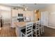 Modern kitchen with granite countertops, white cabinets, stainless steel appliances, and barstool seating at 13806 W Remuda Dr, Peoria, AZ 85383