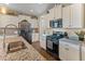 Well-lit kitchen featuring stainless steel appliances, granite countertops, and white cabinetry at 13806 W Remuda Dr, Peoria, AZ 85383