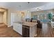 Open kitchen area with granite countertops, white cabinets, and stainless steel appliances with open-concept living space at 13806 W Remuda Dr, Peoria, AZ 85383