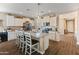 Charming kitchen featuring stainless steel appliances, an island, granite countertops, and white cabinetry at 13806 W Remuda Dr, Peoria, AZ 85383