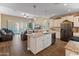 Open-concept kitchen features an island with granite countertops and stainless steel appliances at 13806 W Remuda Dr, Peoria, AZ 85383