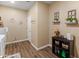 Practical laundry area with shelves and cabinets for storage, and tiled flooring at 13806 W Remuda Dr, Peoria, AZ 85383
