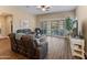 Spacious living room with tile floors, ceiling fan and sliding door offering ample light at 13806 W Remuda Dr, Peoria, AZ 85383