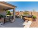 Relaxing covered patio featuring a hot tub, dining set, and cozy seating area for outdoor enjoyment at 13806 W Remuda Dr, Peoria, AZ 85383
