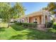Inviting backyard featuring a covered patio and lush landscaping, perfect for relaxation at 14154 W Yosemite Dr, Sun City West, AZ 85375