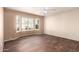 Bedroom with wood-like flooring and bright bay windows with plantation shutters at 14154 W Yosemite Dr, Sun City West, AZ 85375