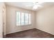 Bedroom featuring hardwood floors, a ceiling fan, and shuttered window allowing natural light at 14154 W Yosemite Dr, Sun City West, AZ 85375