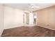 Spacious bedroom featuring hardwood floors, light walls, with a view toward an adjacent bathroom at 14154 W Yosemite Dr, Sun City West, AZ 85375
