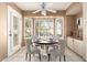 Charming breakfast nook featuring a round table, white cabinets and a window with plantation shutters at 14154 W Yosemite Dr, Sun City West, AZ 85375