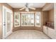 Breakfast nook with white fan, tiled floor, and bright windows with shutters at 14154 W Yosemite Dr, Sun City West, AZ 85375