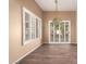 Elegant dining area featuring new wood floors, decorative light fixture, and plantation shutters at 14154 W Yosemite Dr, Sun City West, AZ 85375