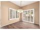 Dining space featuring wood floors, plantation shutters, a modern chandelier, and neutral walls at 14154 W Yosemite Dr, Sun City West, AZ 85375
