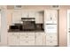 Kitchen with white cabinetry, stone countertops, and modern appliances including microwave and oven at 14154 W Yosemite Dr, Sun City West, AZ 85375