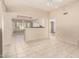 Bright living room featuring tile floors, a ceiling fan, and view into kitchen at 14154 W Yosemite Dr, Sun City West, AZ 85375