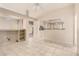 Open concept living room with tile floors and ceiling fan, and views into kitchen at 14154 W Yosemite Dr, Sun City West, AZ 85375