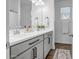 Bright bathroom featuring double sink vanity, decorative mirror, and wood look flooring at 1482 W Gloucester W Rd, San Tan Valley, AZ 85143