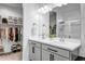 Bathroom with double vanity, ample lighting, and a view into the walk-in closet at 1482 W Gloucester W Rd, San Tan Valley, AZ 85143