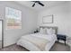 Cozy bedroom featuring neutral decor, ceiling fan, and window with natural light at 1482 W Gloucester W Rd, San Tan Valley, AZ 85143