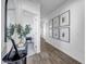 Bright hallway with wood-look tile flooring and decorative artwork at 1482 W Gloucester W Rd, San Tan Valley, AZ 85143