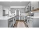Stylish kitchen with stainless steel appliances and gray cabinets at 1482 W Gloucester W Rd, San Tan Valley, AZ 85143