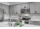 Updated kitchen with stainless steel appliances, gray cabinets, and a center island at 1482 W Gloucester W Rd, San Tan Valley, AZ 85143