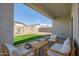 Covered patio with outdoor seating, artificial grass, and neighborhood views at 1482 W Gloucester W Rd, San Tan Valley, AZ 85143