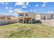 Large backyard featuring block fence, some grass, and back of two-story house at 1518 W Crape Rd, San Tan Valley, AZ 85140
