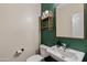 Well-lit half bathroom featuring stylish decor and a modern sink, offering convenience and charm for guests at 1518 W Crape Rd, San Tan Valley, AZ 85140