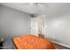 Comfortable bedroom with wood-look floors, ceiling fan, and view of stairway at 1518 W Crape Rd, San Tan Valley, AZ 85140