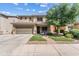 Charming two-story home boasts a manicured lawn and inviting covered porch, perfect for relaxing outdoors at 1518 W Crape Rd, San Tan Valley, AZ 85140