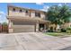 Inviting home featuring an attached two-car garage and well-maintained landscaping for great curb appeal at 1518 W Crape Rd, San Tan Valley, AZ 85140