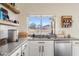 Kitchen features granite countertops, stainless steel appliances, and backyard views from window above sink at 1518 W Crape Rd, San Tan Valley, AZ 85140