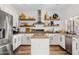 Modern kitchen boasts white cabinetry, stainless steel appliances, and a central island, perfect for culinary enthusiasts at 1518 W Crape Rd, San Tan Valley, AZ 85140