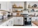 Bright kitchen with white cabinets, granite countertops, subway tile backsplash, and stainless steel appliances at 1518 W Crape Rd, San Tan Valley, AZ 85140