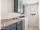 Functional laundry room featuring counter space and upper cabinets and neutral wall paint at 1518 W Crape Rd, San Tan Valley, AZ 85140