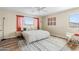 Serene main bedroom featuring large windows, luxury vinyl plank flooring, and a cozy rocking chair at 1518 W Crape Rd, San Tan Valley, AZ 85140