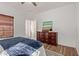 Bedroom featuring a ceiling fan, hardwood floors, and a dresser at 15246 N 138Th Ln, Surprise, AZ 85379