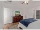 Bedroom with stylish dresser, ceiling fan, and hardwood floors at 15246 N 138Th Ln, Surprise, AZ 85379