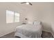 Neutral bedroom with carpet, window, and a bed with white linens and decorative pillows at 15246 N 138Th Ln, Surprise, AZ 85379