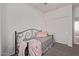 Comfortable bedroom featuring carpet, daybed with a cozy throw, and a closet with sliding doors at 15246 N 138Th Ln, Surprise, AZ 85379