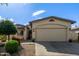 Charming home with a two-car garage, well-manicured yard, and appealing desert landscaping at 15246 N 138Th Ln, Surprise, AZ 85379