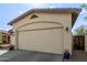 Close up of a two car garage with desert landscaping including rock and plants at 15246 N 138Th Ln, Surprise, AZ 85379
