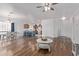 Open concept living room with hardwood floors adjacent to the dining area and kitchen at 15246 N 138Th Ln, Surprise, AZ 85379