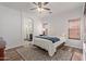 Comfortable main bedroom with a ceiling fan and ensuite bathroom at 15246 N 138Th Ln, Surprise, AZ 85379