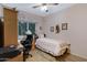 Comfortable bedroom features a twin bed, desk, and wood floors with a view to the outside at 16450 E Avenue Of The Fountain -- # 47, Fountain Hills, AZ 85268
